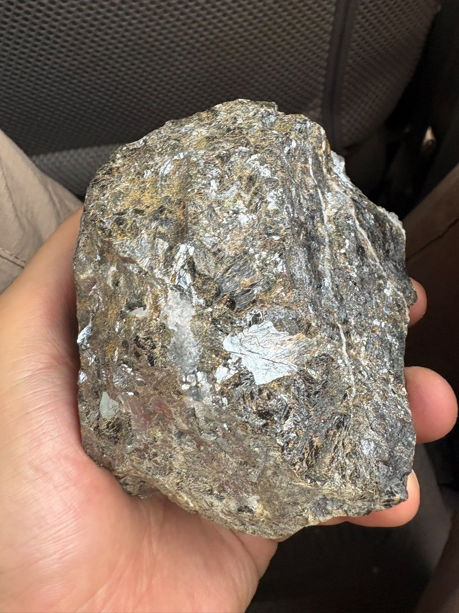 Ore sample held in hand